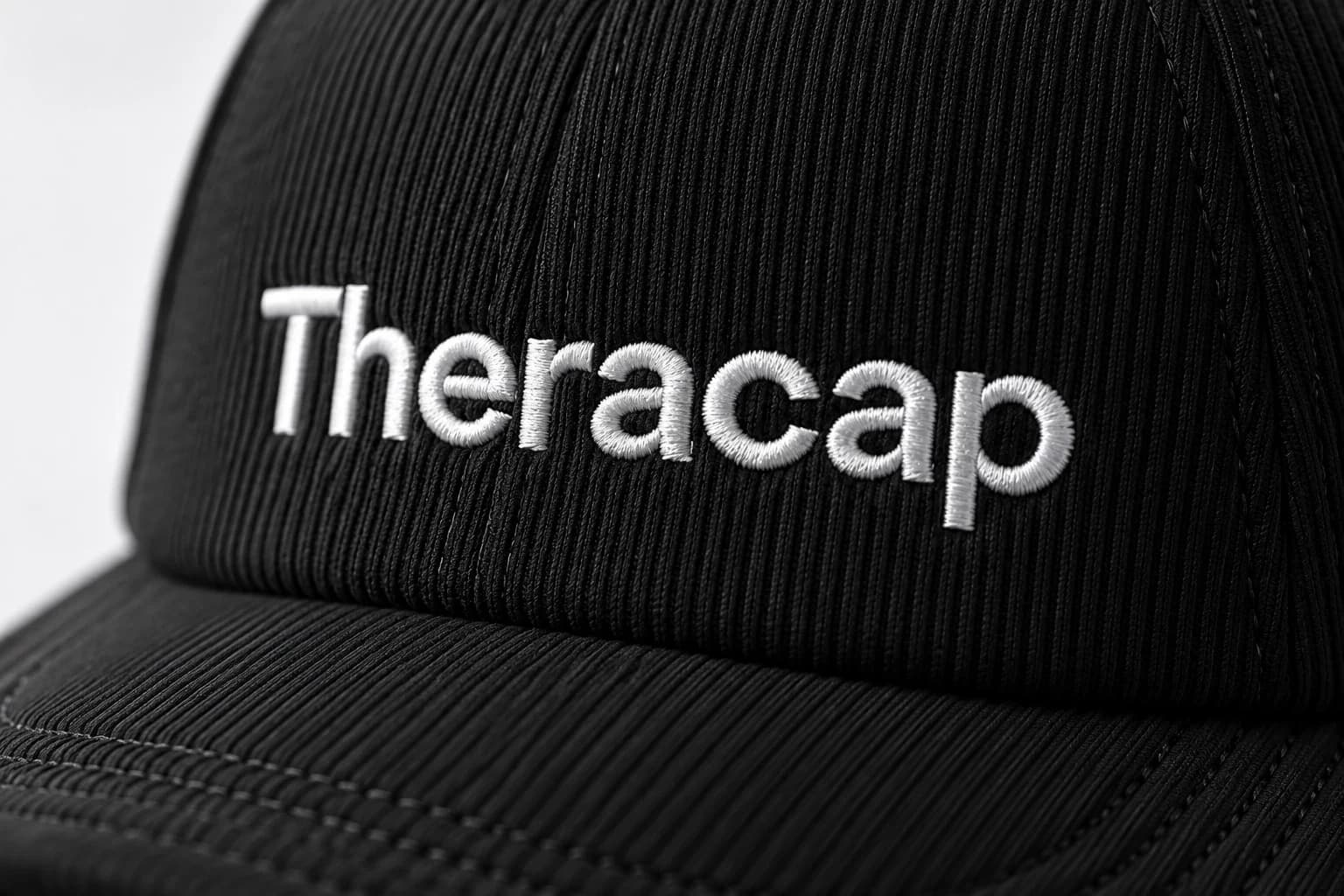Close-up of the Theracap wordmark and ribbed fabric