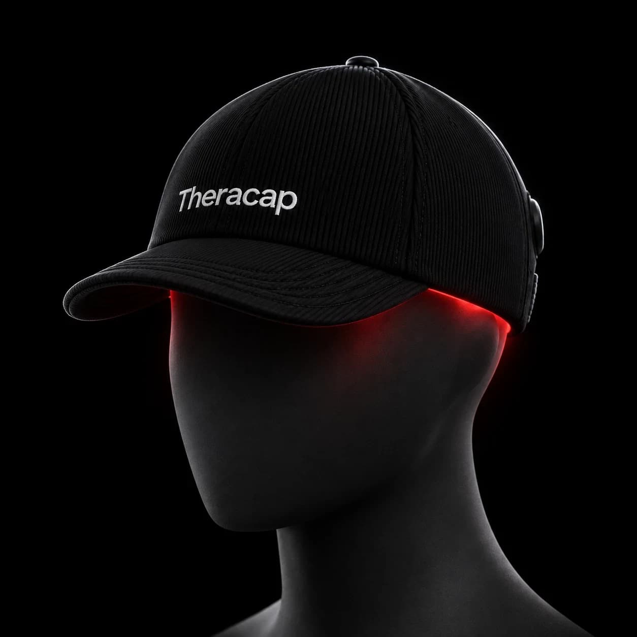 Theracap worn on a sculptural head form in the dark, a thin line of red light at the rim